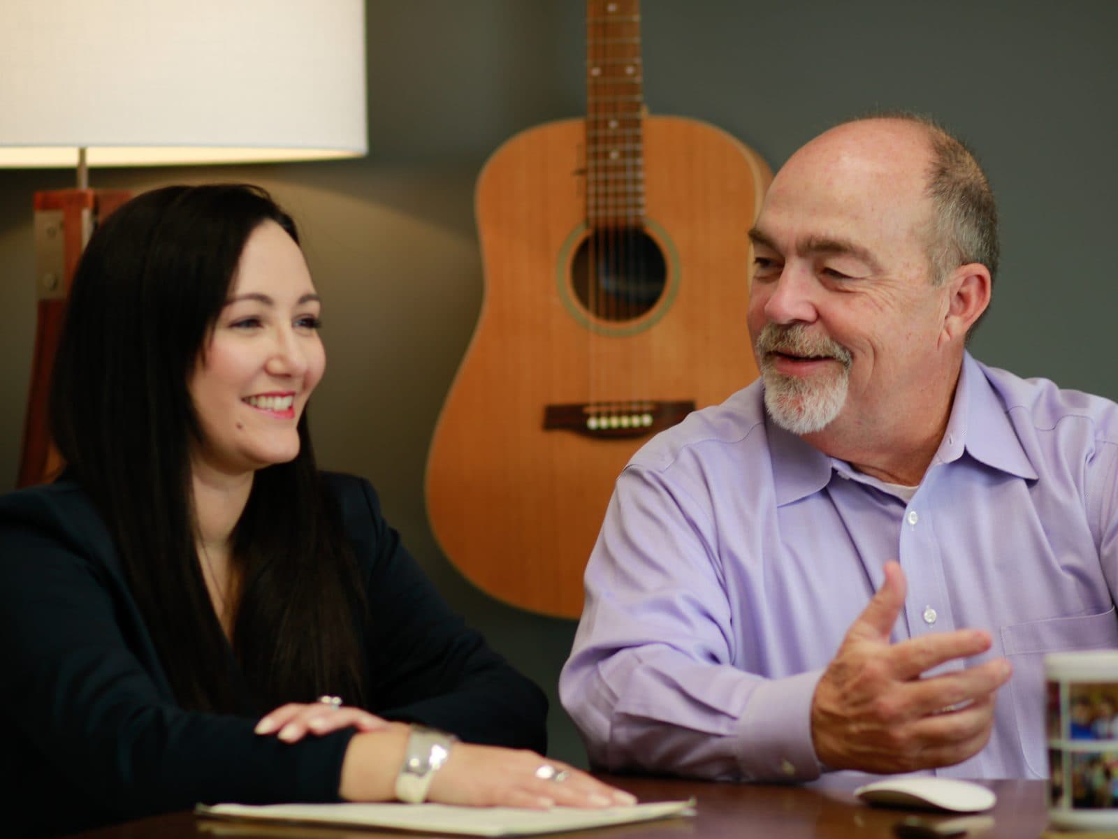 Bienvenue Wealth advisors Sara Sroka and Michael Rivas talking in the firm's New Orleans office